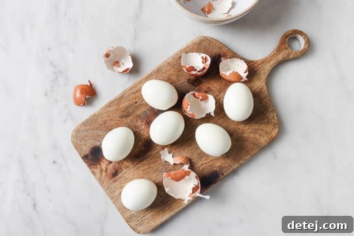Peeled hard-boiled eggs laid out, ready for preparation.
