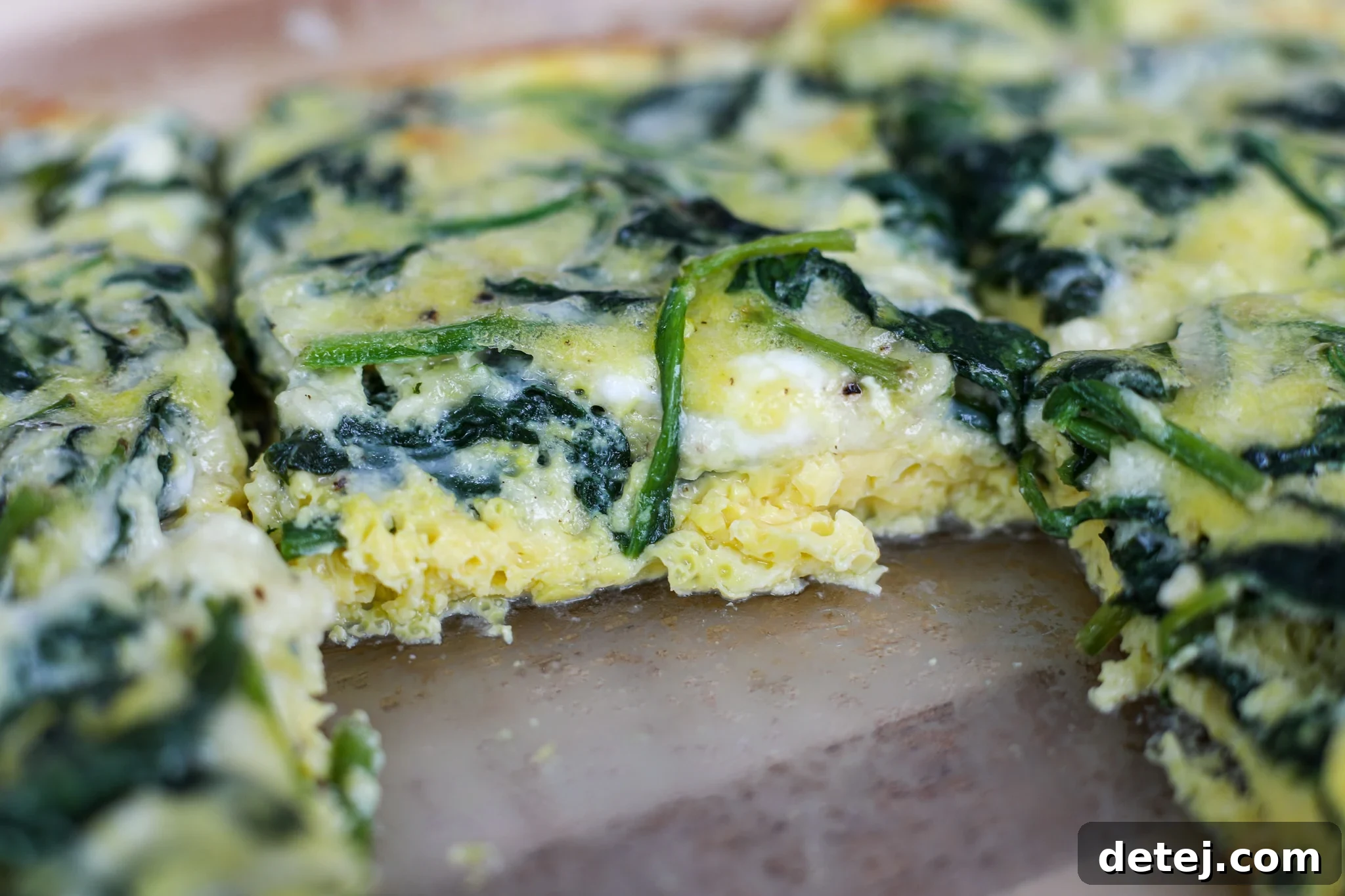 Savory Spinach and Cheesy Baked Eggs 3 Preparing the mixture for Cheesy Spinach Baked Eggs in a mixing bowl before baking. Shows the vibrant green of wilted spinach combined with eggs and cheese.