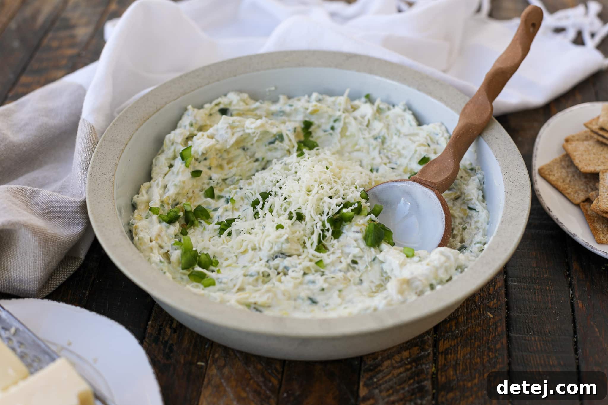 Healthyish Jalapeno Artichoke Cheese Dip served with a variety of fresh vegetables and crackers.