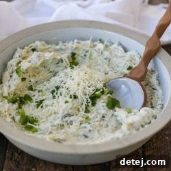 Healthyish Jalapeno Artichoke Cheese Dip, ready to serve with dippers.