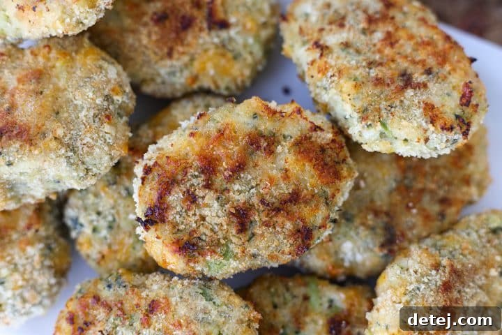 A serving of Homemade Broccoli Cheddar Chicken Nuggets with a side of dipping sauce.