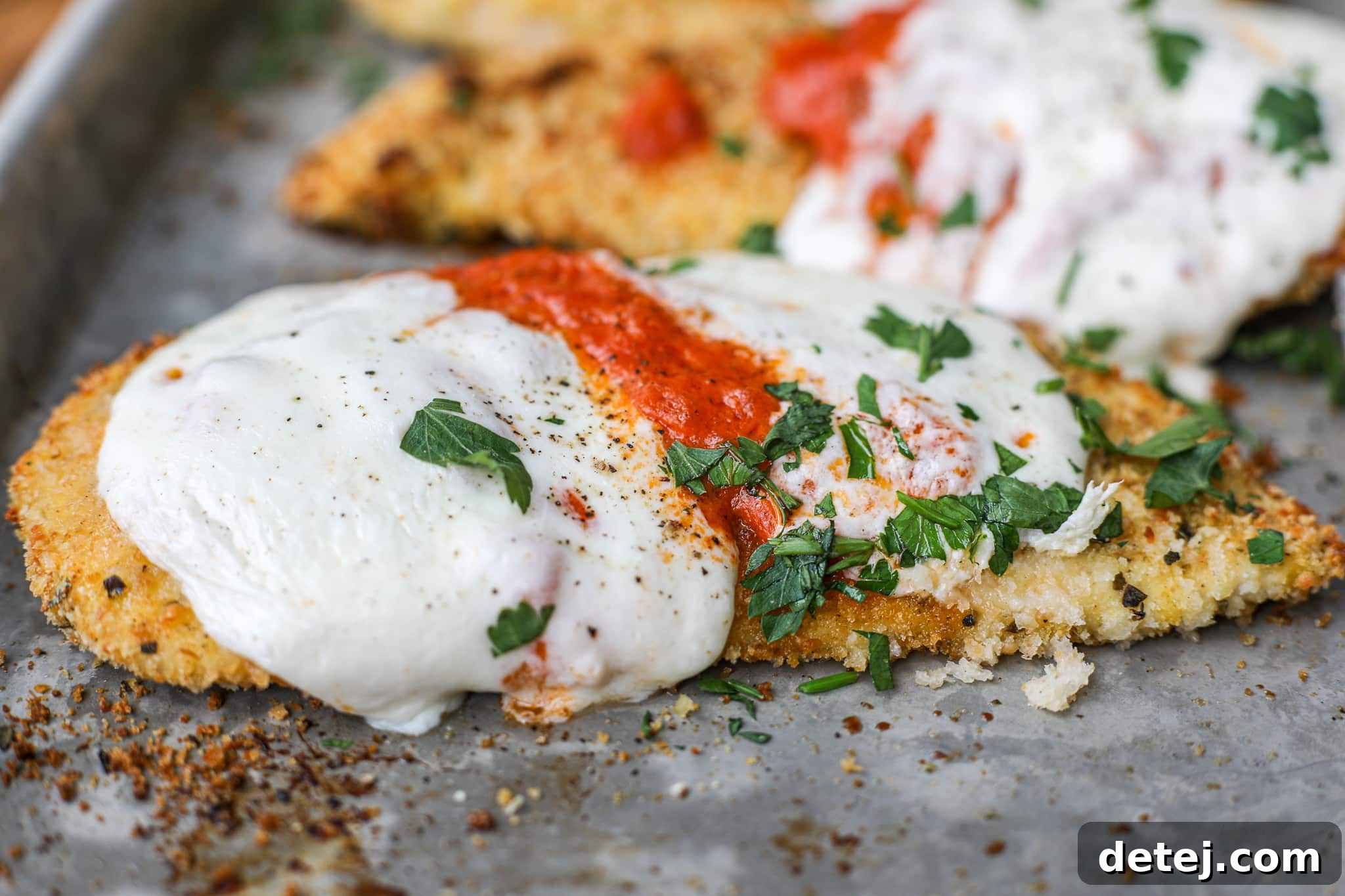 Baked Chicken Vodka Parmesan garnished with fresh parsley