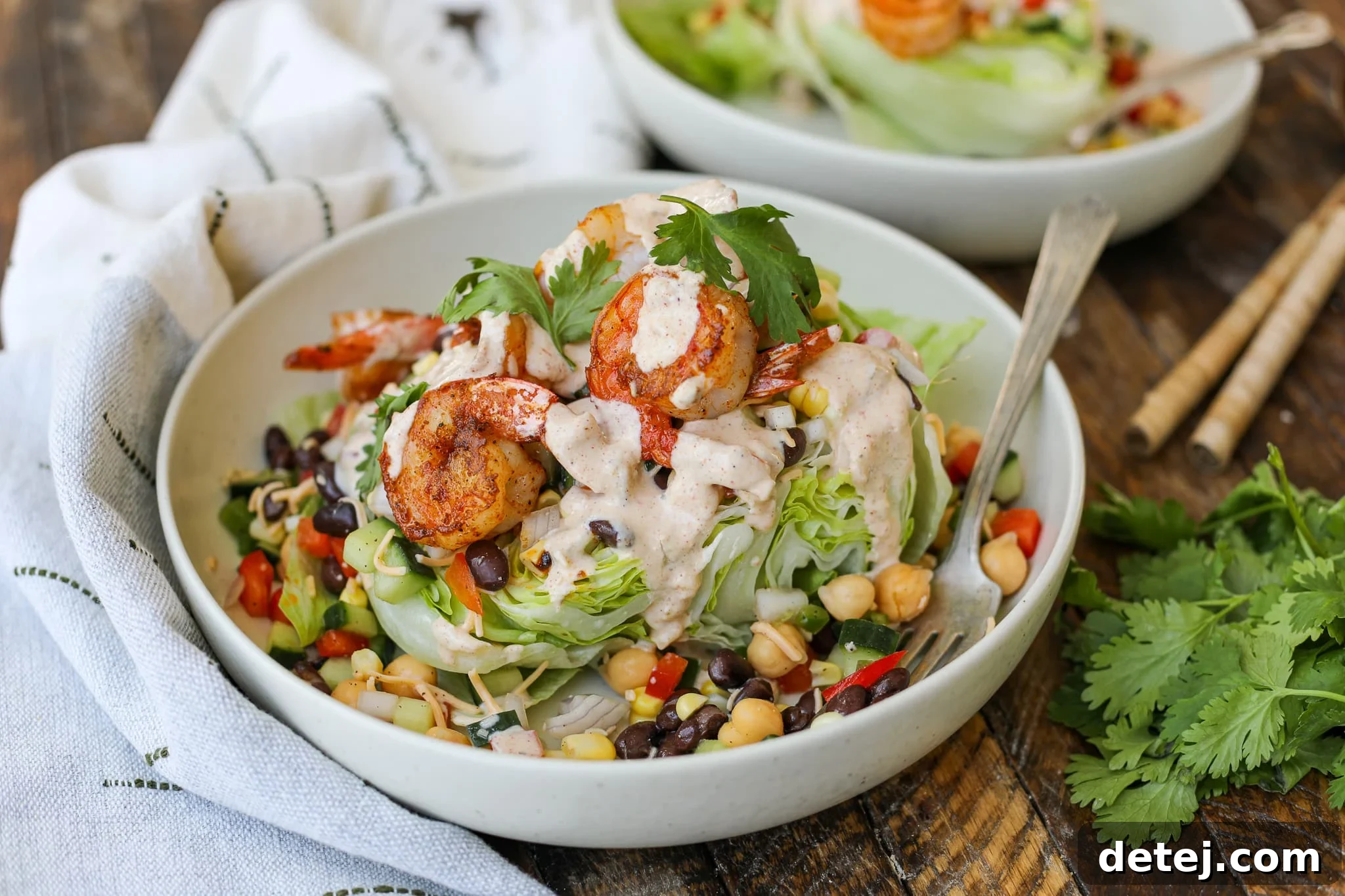 Blackened Shrimp Southwest Wedge Salad, featuring juicy blackened shrimp, crisp iceberg lettuce, and a vibrant medley of Southwest vegetables, drizzled with a creamy chili-lime yogurt dressing.