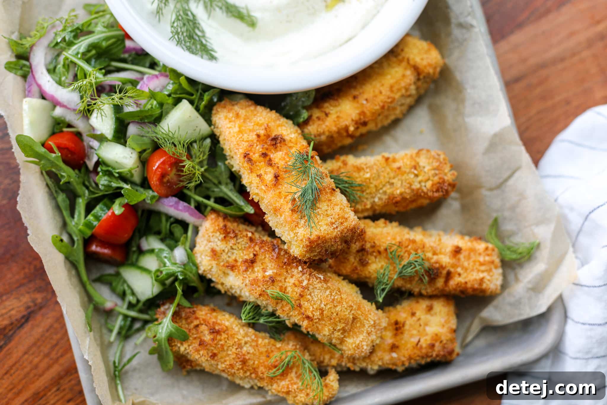Ingredients for Air Fryer Salmon Fish Sticks including salmon, breading bowls, feta dip ingredients, and salad components.