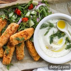 Crispy Air Fryer Salmon Fish Sticks served with a creamy whipped feta dip and a fresh side salad.
