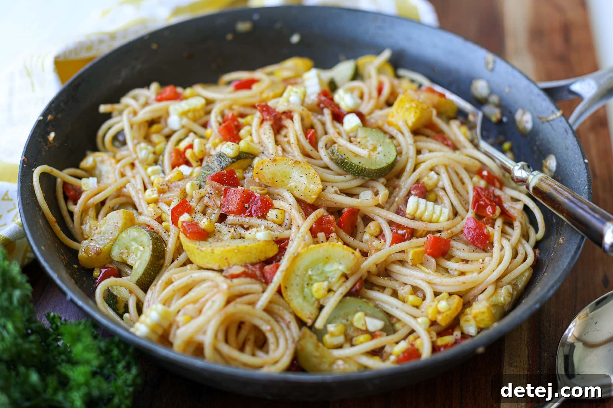 Vibrant Spring Pasta 3 Close-up of fresh vegetables being sautéed in a large pan for Pasta Primavera, highlighting their vibrant colors.
