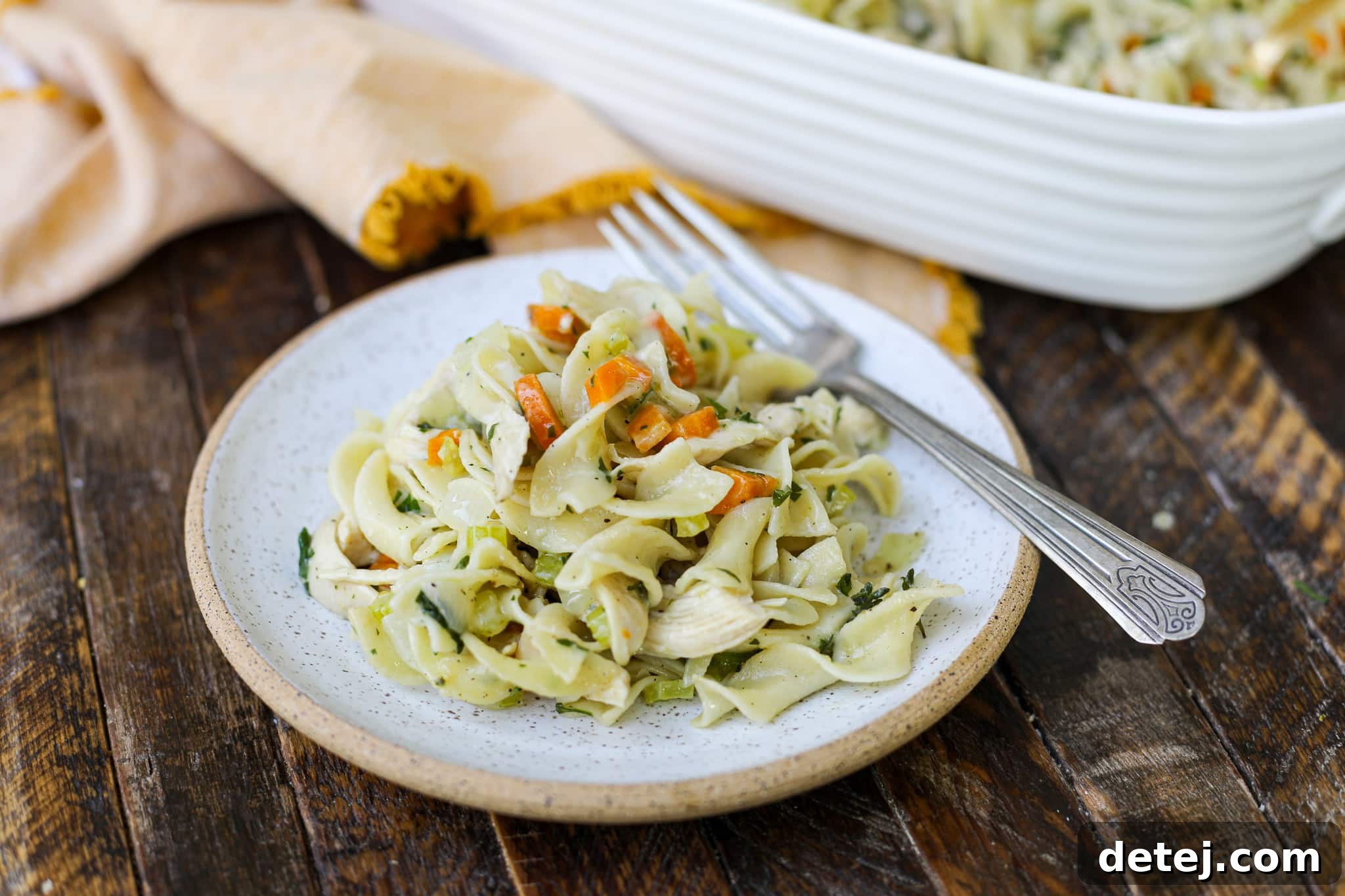 A serving of Chicken Noodle Soup Pasta Bake on a plate, showing the creamy noodles, chicken, and melted cheese.