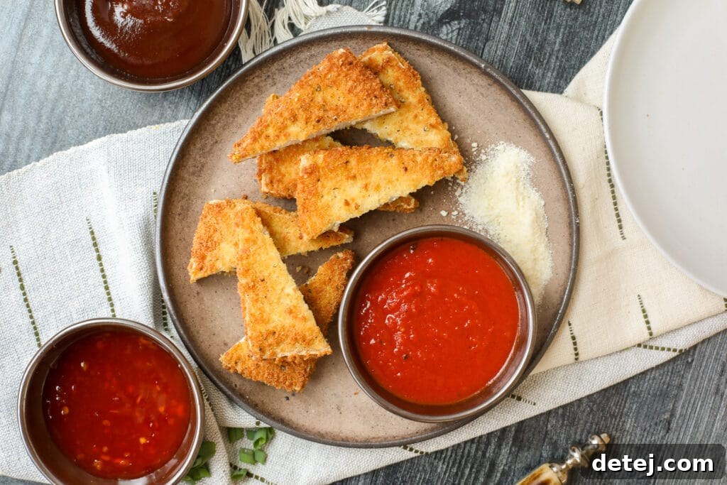 Close-up of crispy tofu cutlet with dipping sauce