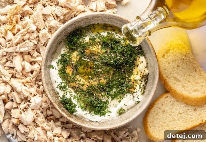 Mixing bowl with dressing ingredients being whisked.