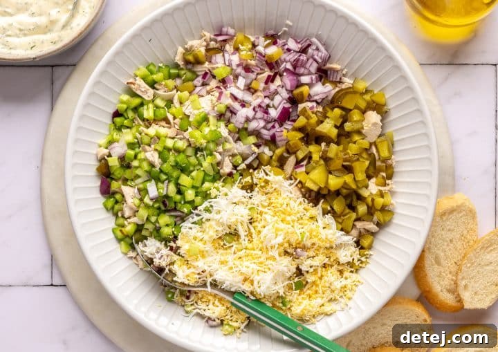 All prepared ingredients for chicken salad in a large mixing bowl.