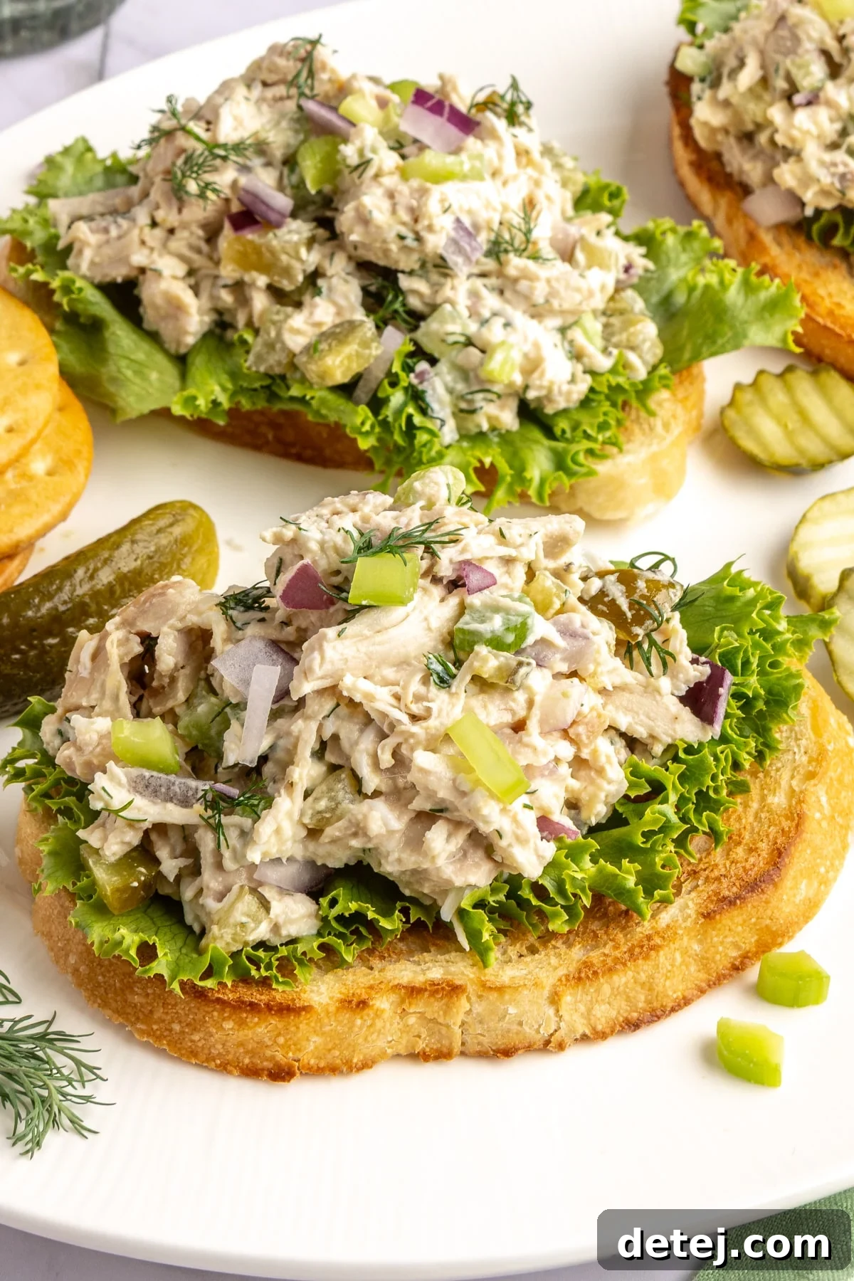 Dill pickle chicken salad served on toasted bread with lettuce.