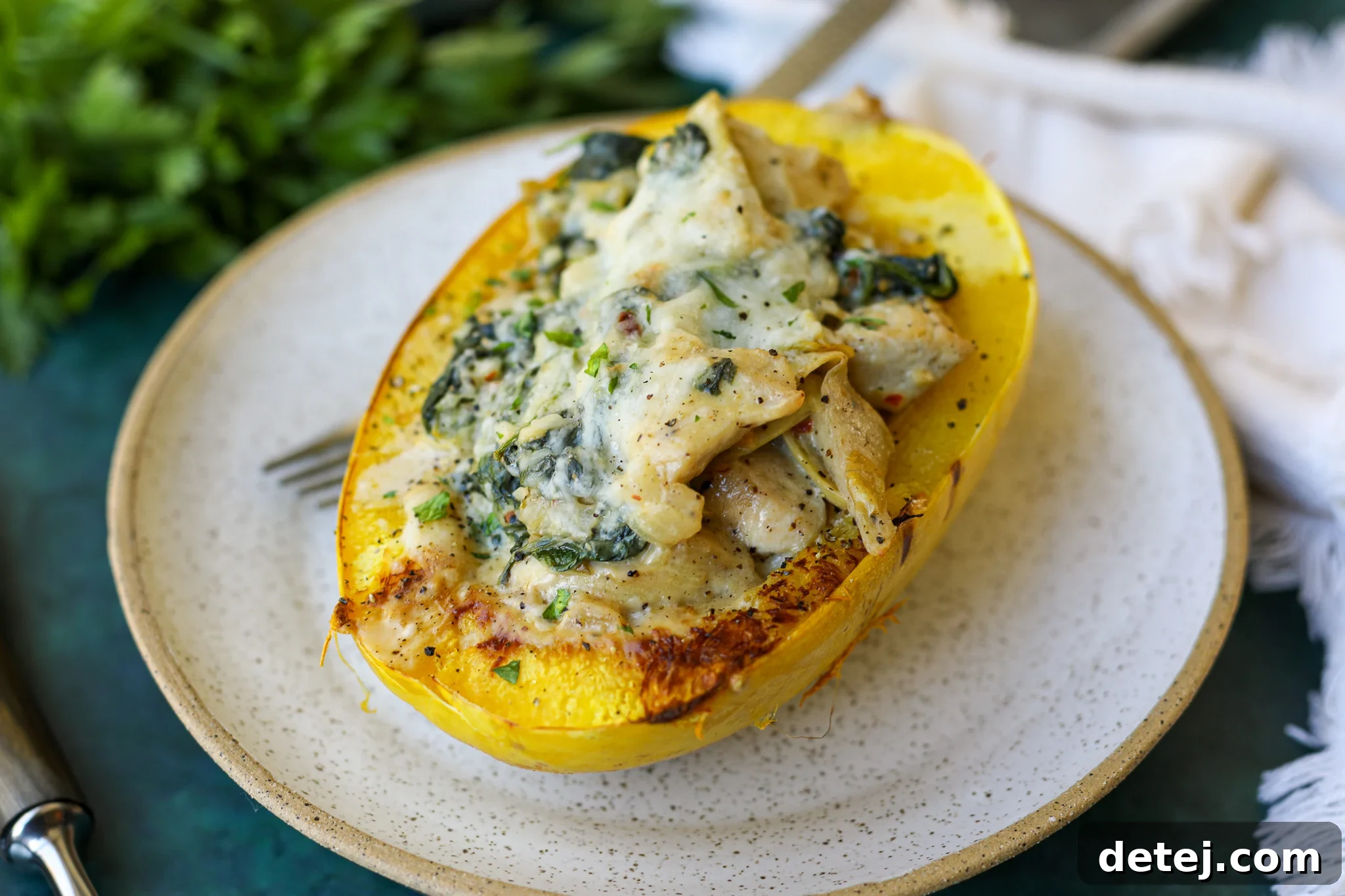 Half of a perfectly roasted spaghetti squash, showing its distinctive pasta-like strands, ready to be stuffed.