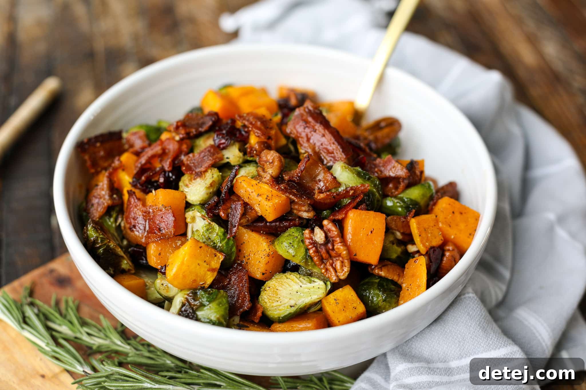 A vibrant bowl of Roasted Butternut Squash and Brussels Sprouts Salad, ready to be served, showcasing its rich colors and textures.