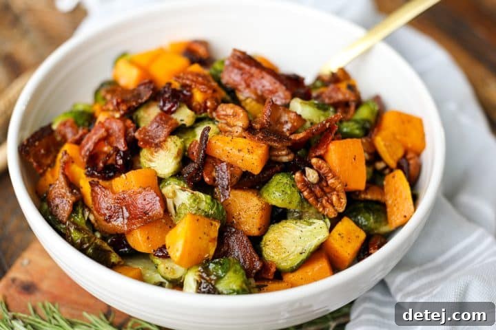 The finished Roasted Butternut Squash and Brussels Sprouts Salad, perfectly dressed and topped with crispy bacon.