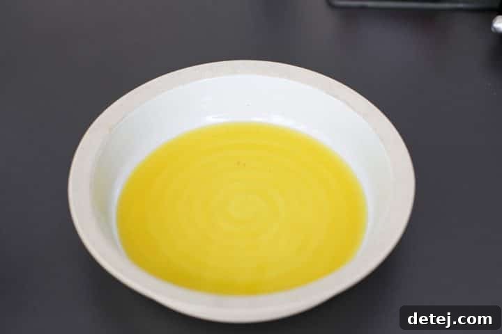 Luscious Burrata Bruschetta Dip 5 A beautiful serving bowl with a glistening pool of extra virgin olive oil at the bottom, ready for the next ingredients.
