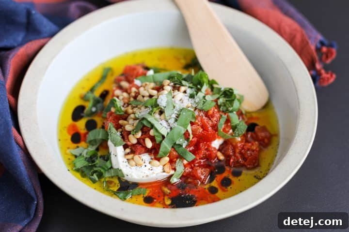 Luscious Burrata Bruschetta Dip 10 The final Burrata Bruschetta Dip, garnished with fresh basil, flaky sea salt, and freshly cracked black pepper, ready to be devoured.