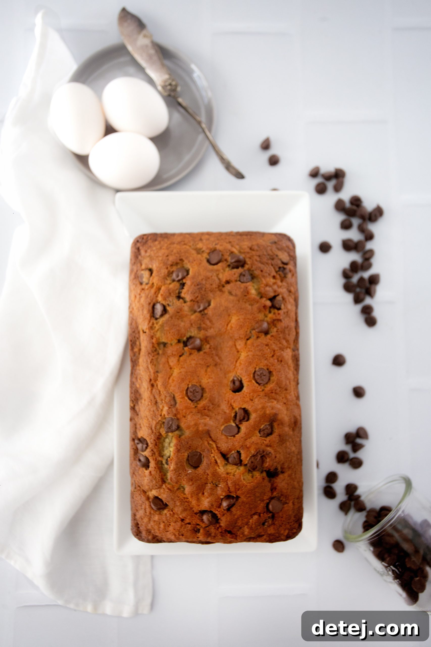A close-up of a slice of chocolate chip banana bread showing its moist texture and melted chocolate chips.