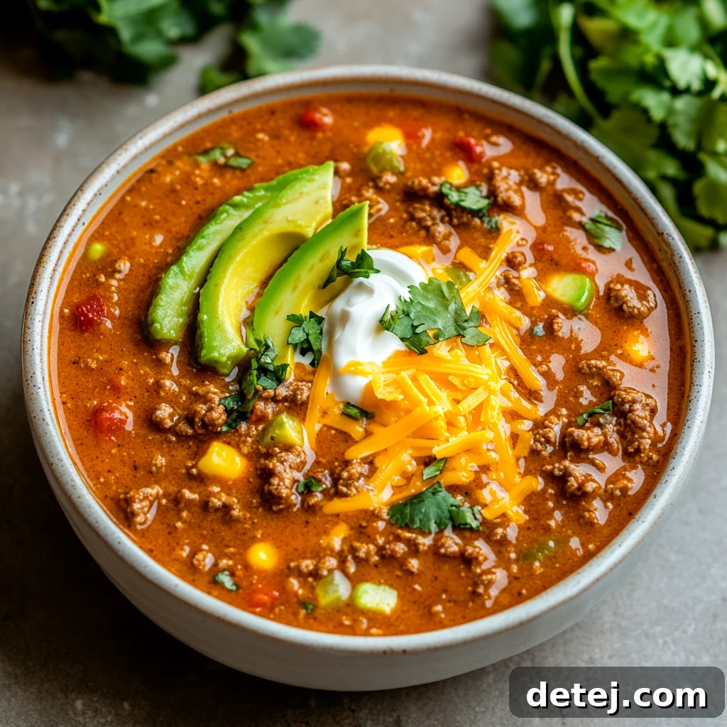 Ground Beef Enchilada Soup topped with fresh cilantro and sour cream