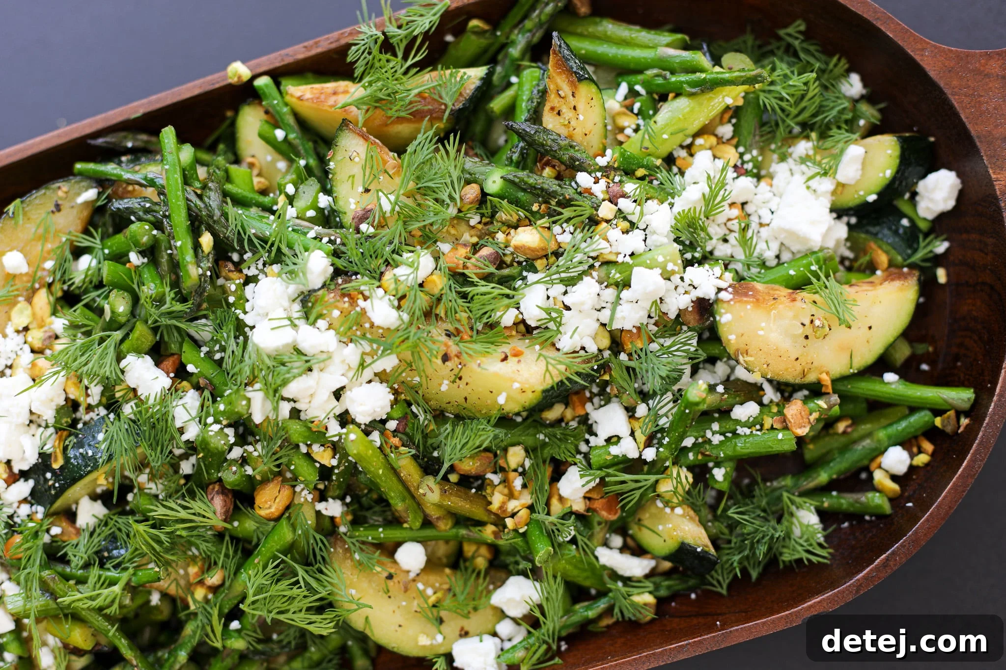Vibrant Sautéed Spring Vegetable Salad topped with feta, pistachios, and fresh dill, ready to be served as a healthy side dish or light main.