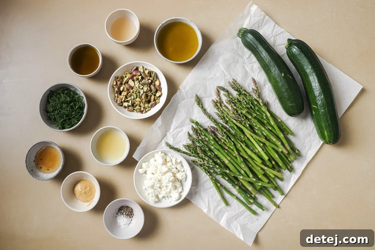 Fresh ingredients laid out for Sautéed Spring Vegetable Salad, including vibrant zucchini, crisp asparagus, crumbled feta, and salted pistachios.