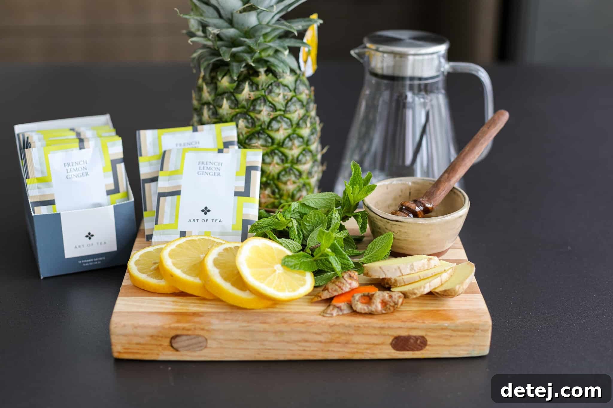 Pineapple Rind Infusion 4 All ingredients for Pineapple Peel Infused Tea laid out on a wooden board, including pineapple peel, ginger, turmeric, lemon, mint, and honey.