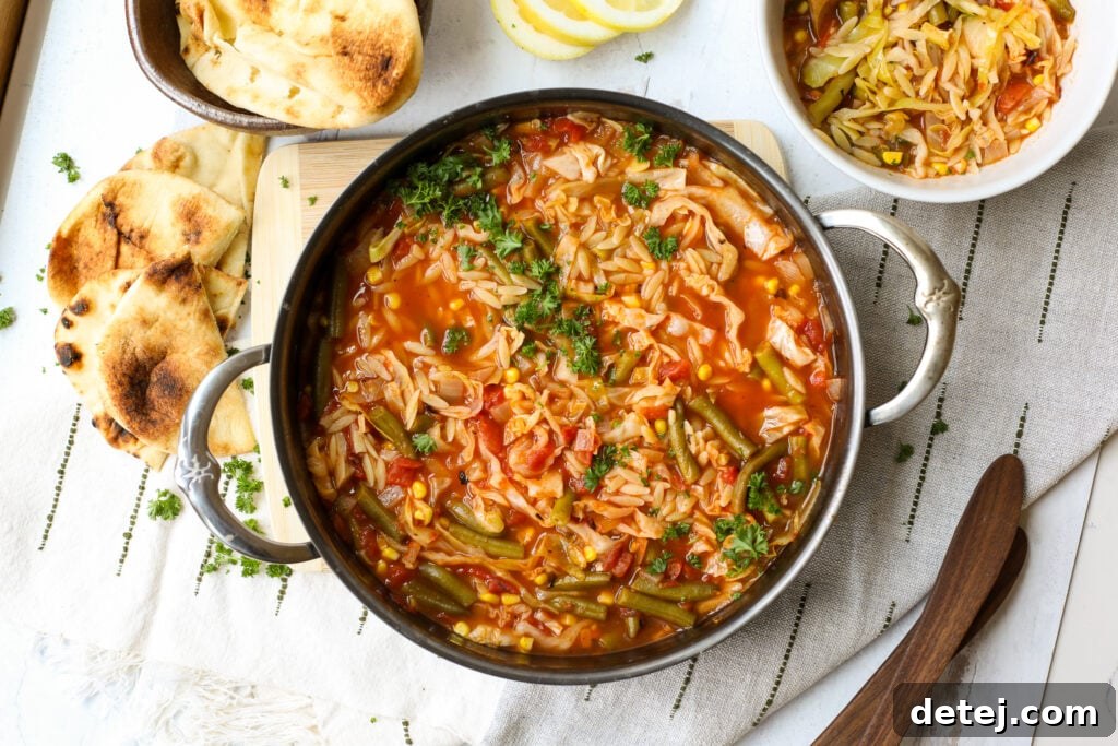 Savory Cabbage Soup with Tender Orzo 3 A close-up shot of raw green cabbage, showcasing its crisp leaves and vibrant color, ready to be prepared for a healthy and delicious meal.