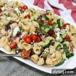 Finished Greek Pasta Salad in a bowl, a fresh and easy Mediterranean dish with pasta, vegetables, feta, and olives.