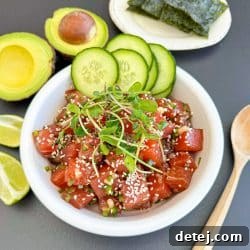 Homemade Ahi Tuna Poke Bowl, garnished with sesame seeds and green onions.