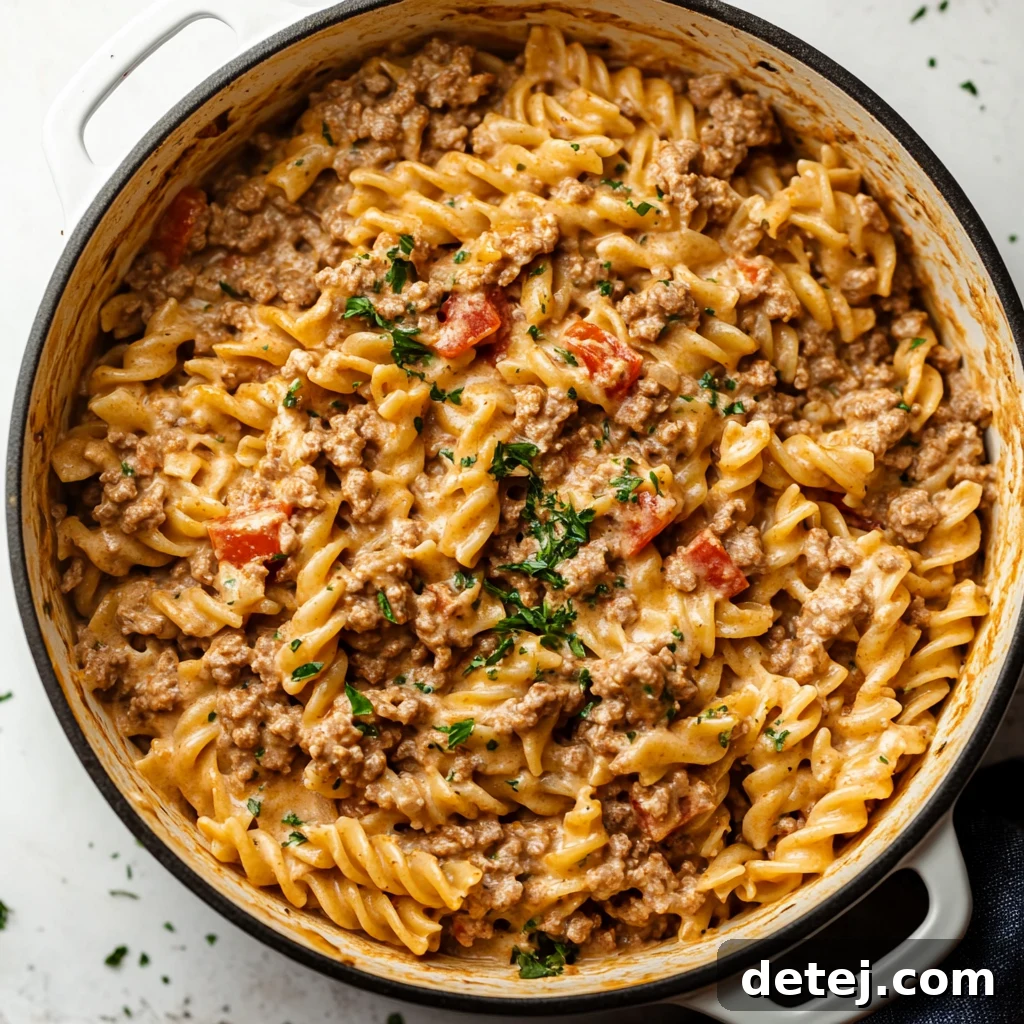 Creamy Ground Beef Skillet Pasta 3 Stovetop Creamy Ground Beef Pasta served in a white bowl with a fork, showing the creamy sauce and ground beef.