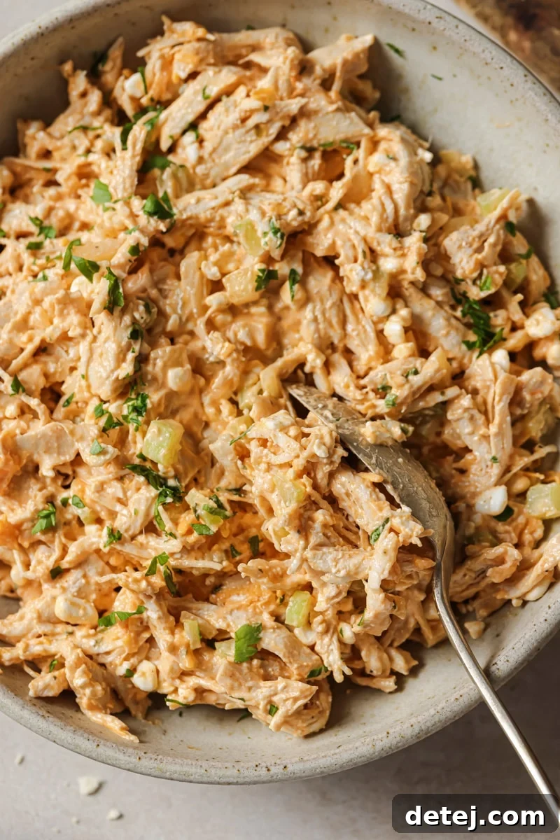 A generous serving of spicy buffalo chicken salad, perfectly mixed and presented in a bowl.