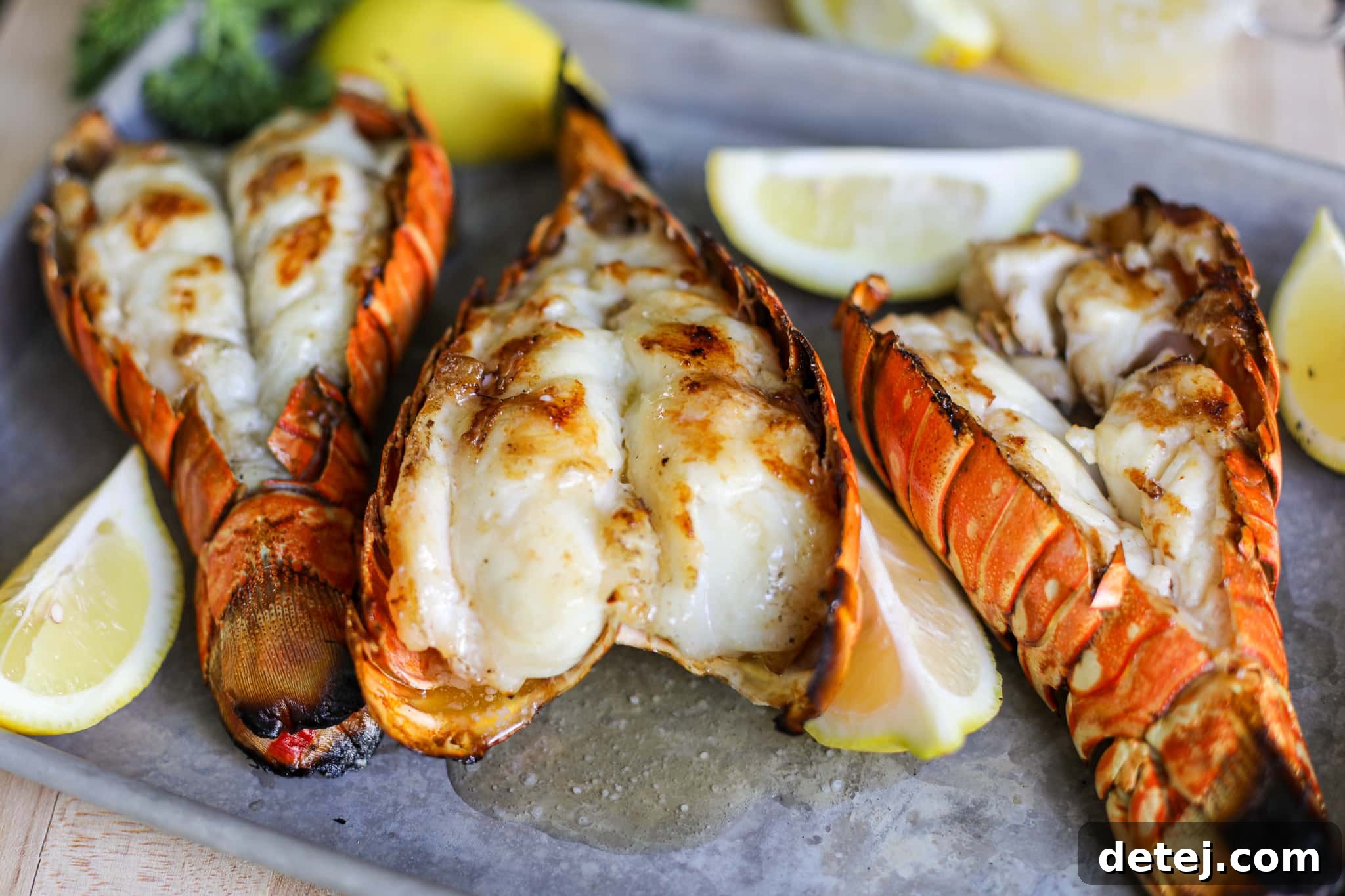 Close-up of butterflied lobster tail meat ready for the grill, showcasing its pristine texture.