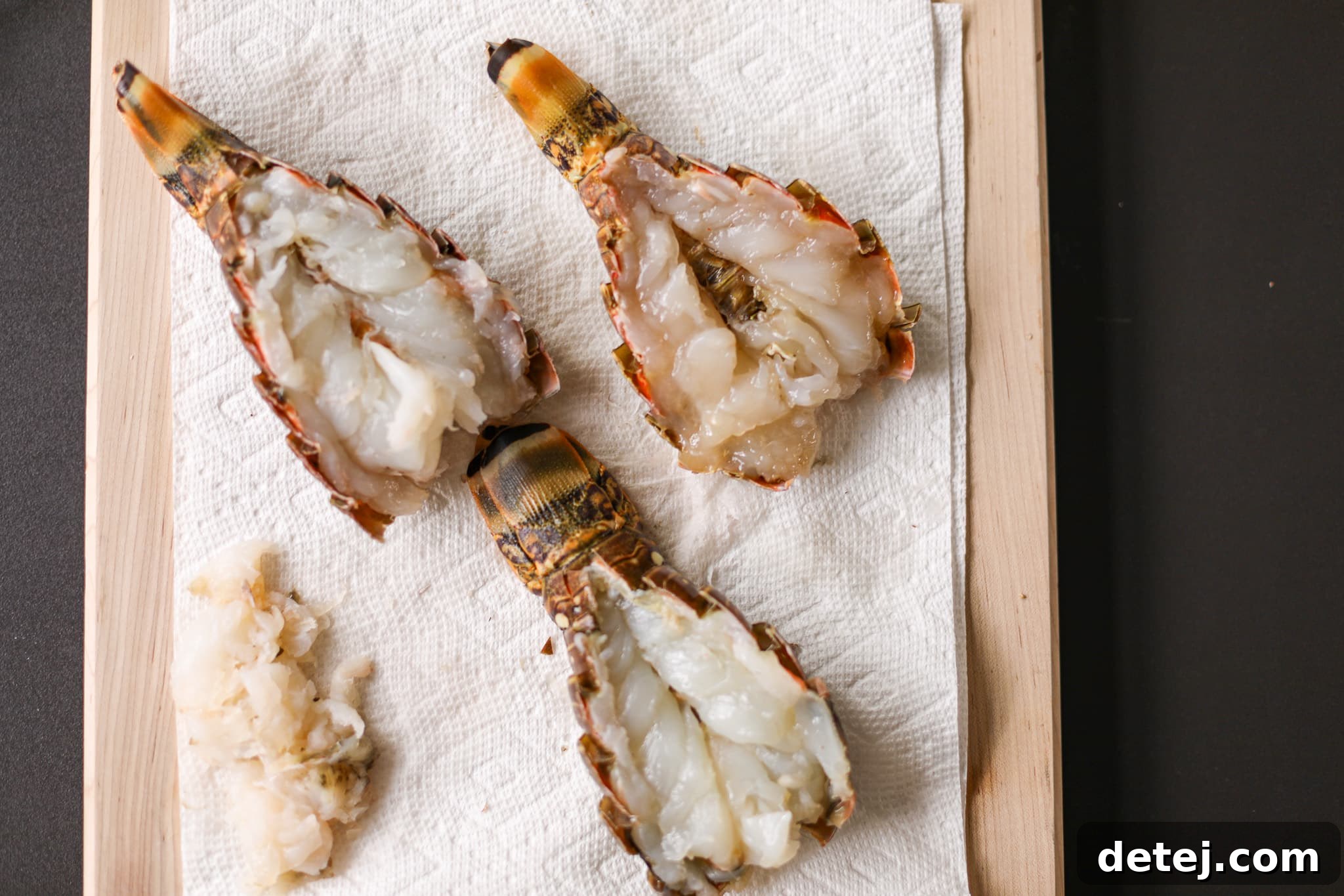 The perfectly prepared lobster tails, butterflied and seasoned, waiting to be placed on the grill.