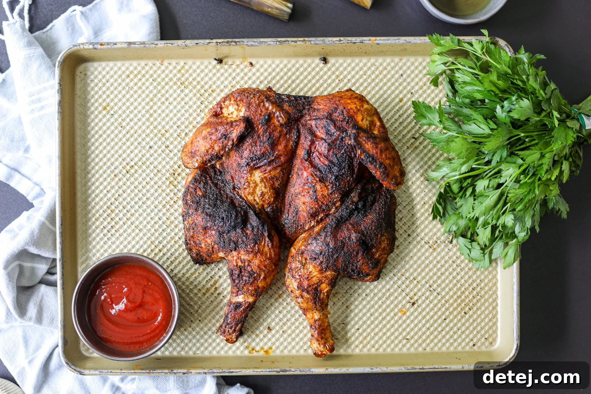 Close-up of a juicy grilled whole chicken, ready to be carved.