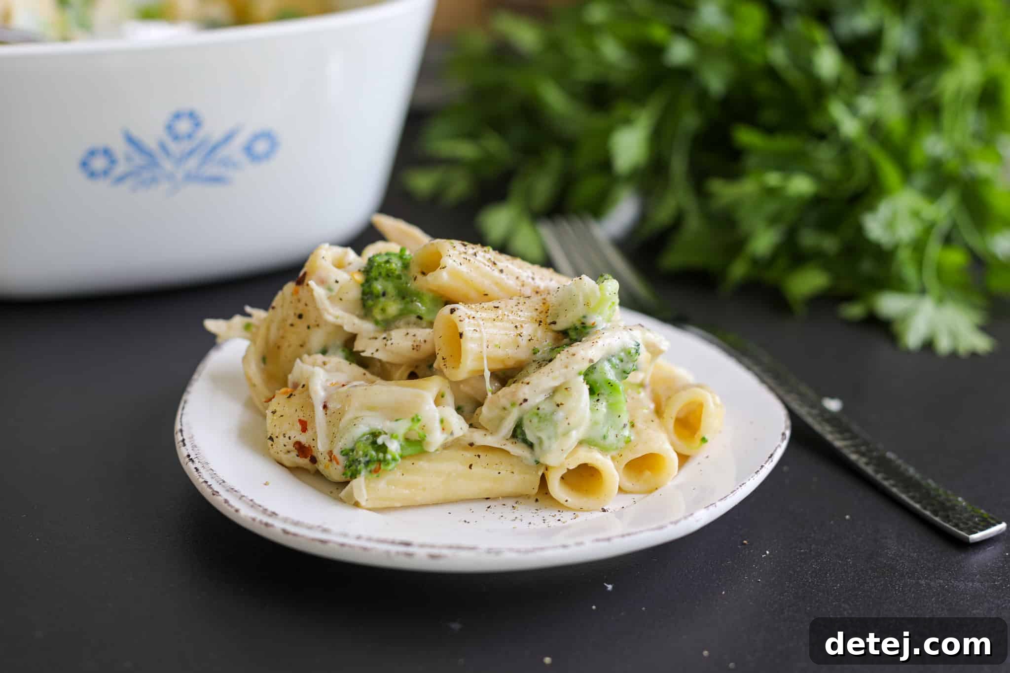 A single scoop of the delectable chicken broccoli pasta bake, ready to be enjoyed.