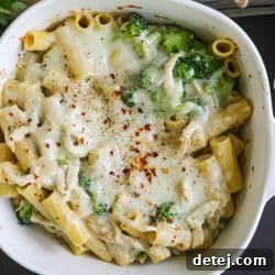 Chicken Broccoli Pasta in a bowl. Baked with cheese on top.