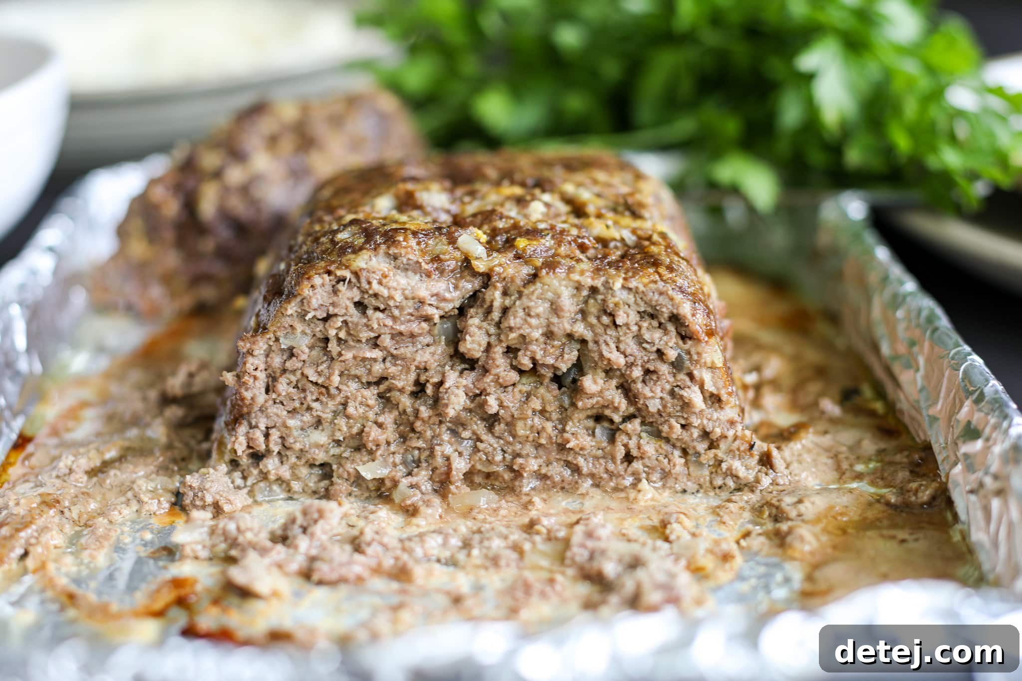 Interior view of a perfectly cooked meatloaf, showing its juicy and tender texture when sliced.