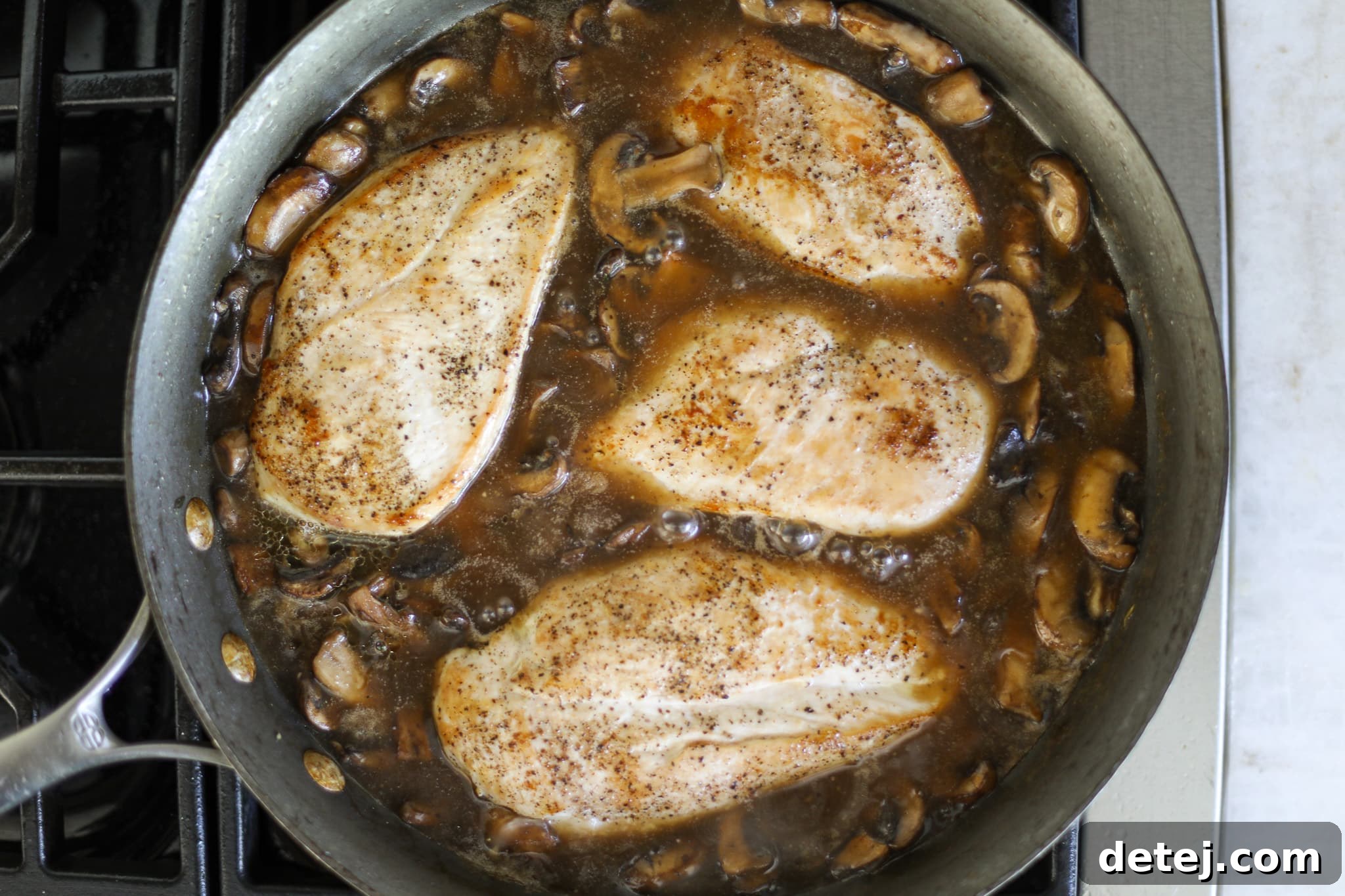 chicken and gravy in a pan. 