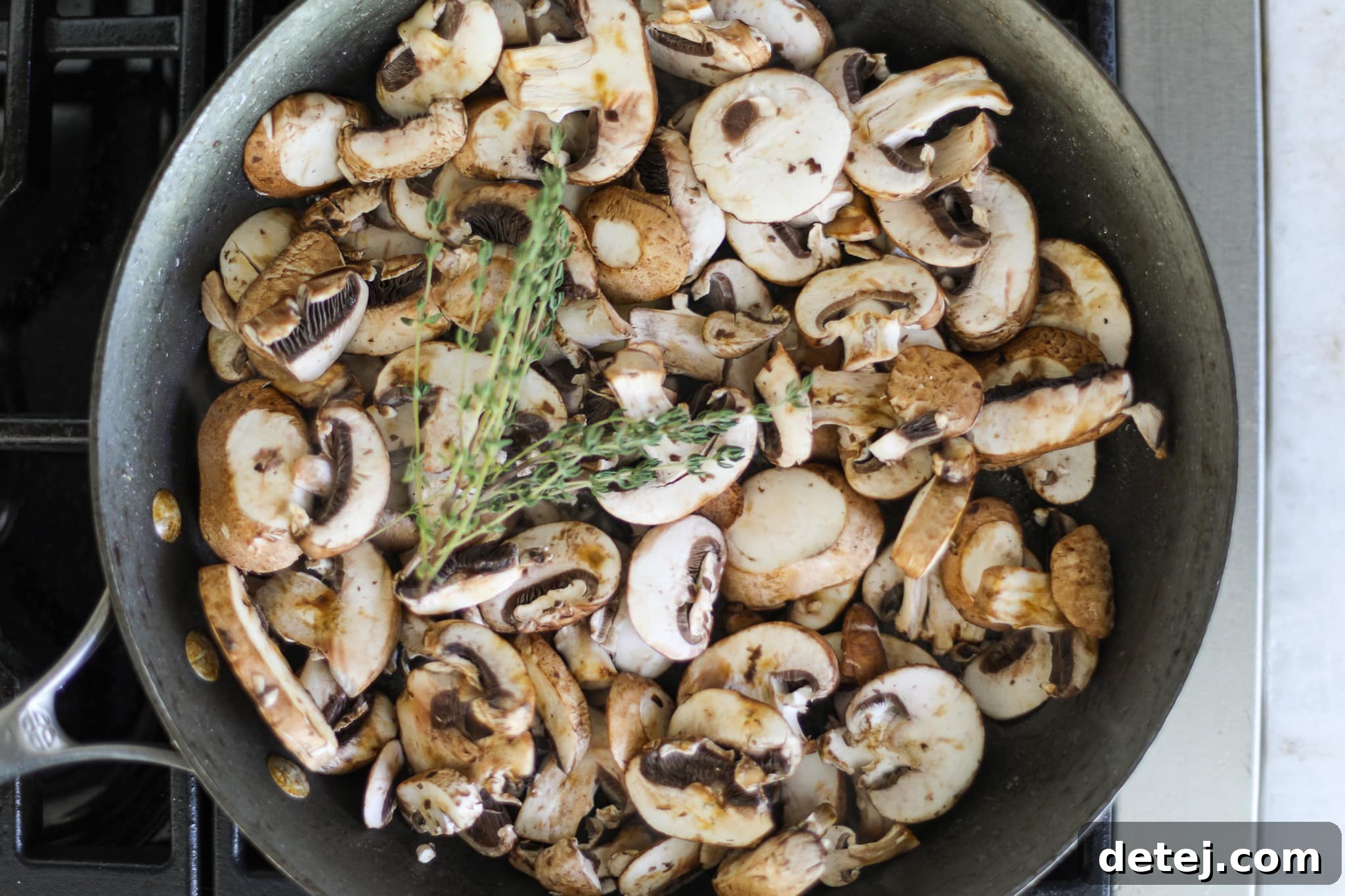 Mushrooms and thyme in a hot pan with butter. 