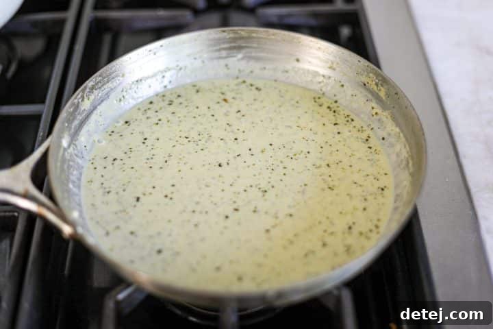 creamy pesto sauce in a pan, fully combined and at desired thickness.