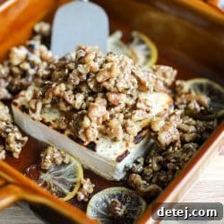 Beautifully baked feta cheese with a honey glaze, adorned with sticky, spiced walnuts.