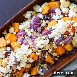 A serving bowl filled with the Roasted Butternut Squash, Cauliflower, and Red Onion, ready to be enjoyed.