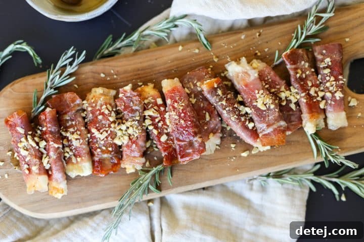 Crispy Prosciutto Wrapped Boursin Cheese with Honey and Chopped Nuts garnished and ready to serve.