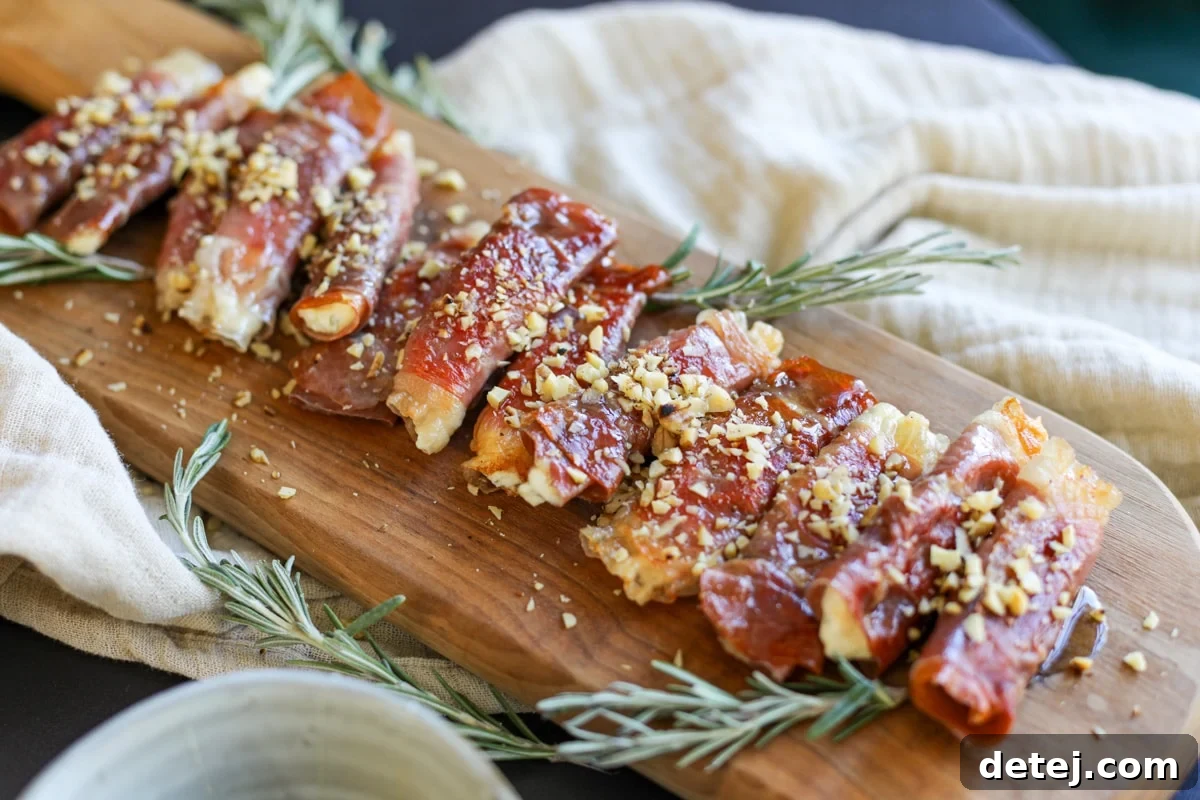A close-up of Crispy Prosciutto Wrapped Boursin Cheese with honey and nuts, highlighting its gourmet appeal.