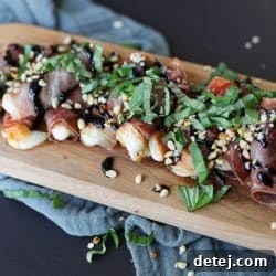 Crispy Prosciutto and Mozzarella Roll-Ups on a serving tray, garnished with fresh basil and balsamic glaze.
