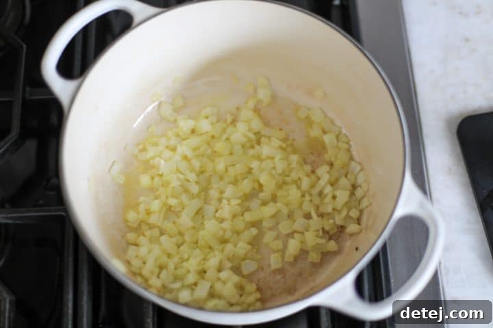 onions and garlic sautéing in a pan.