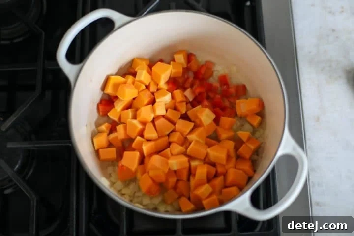 Vegetables sautéing in a pot with avocado oil.