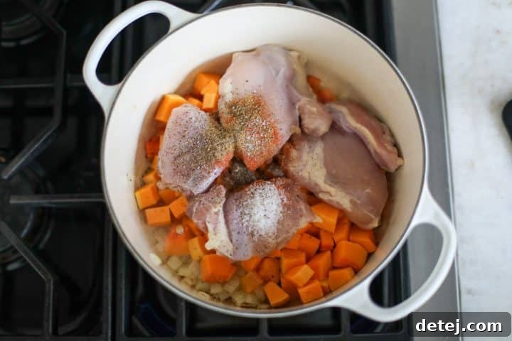 vegetables and chicken thighs in a pot with seasoning.