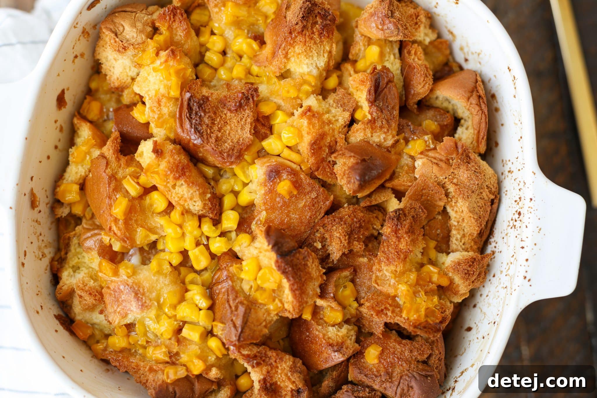 A dish of creamy cornbread pudding, a comforting Thanksgiving side.