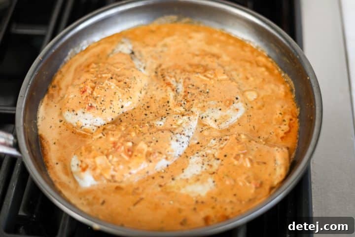 The fully assembled creamy sun-dried tomato pesto chicken dish, ready to be served directly from the pan.