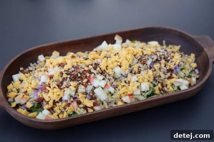 The Chopped Fall Pasta Salad, now fully assembled with all ingredients and dressing, in a large mixing bowl, ready for a final toss.